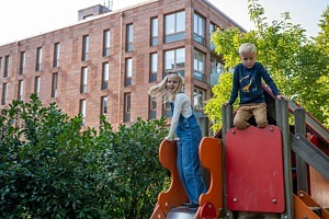 två barn på rutschkana på lekplats